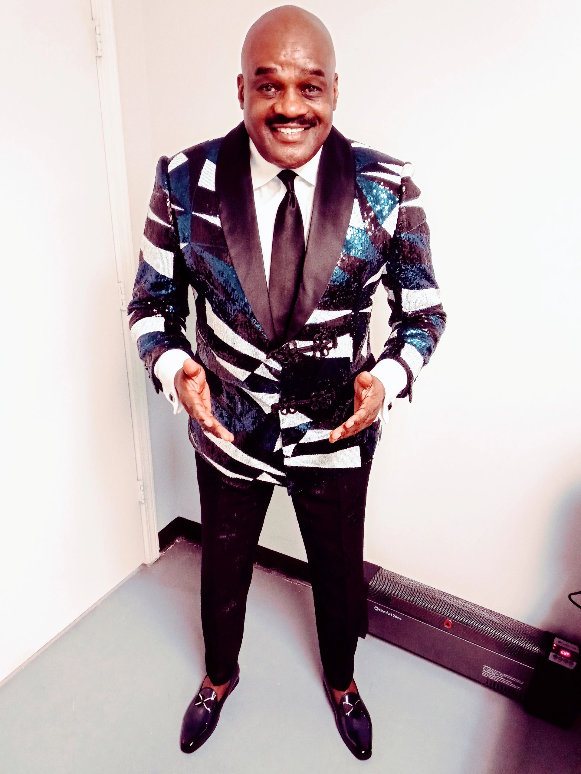 Julius Williams in purple blue sequined blazer smiling portrait
