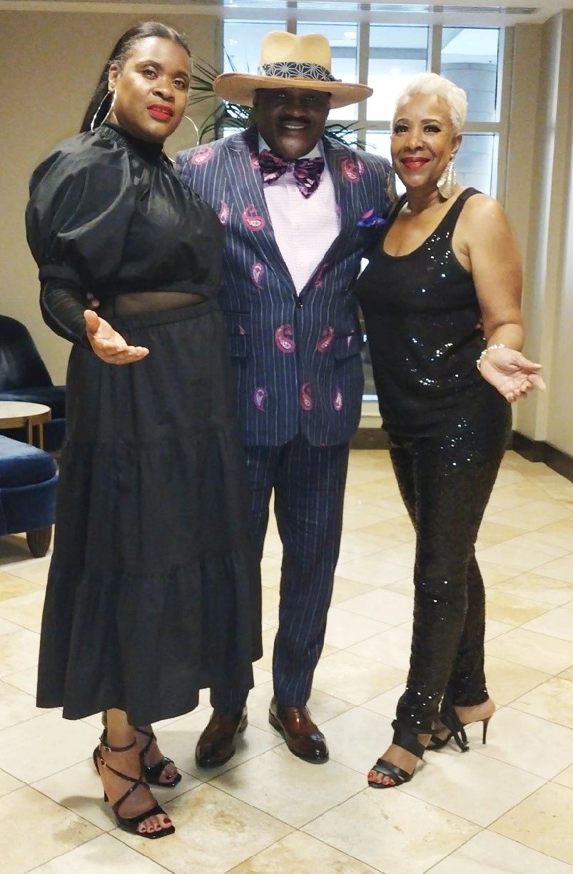 Julius Williams in navy pinstripe suit with purple bow tie at formal event