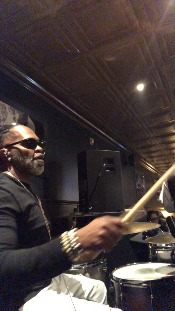 Kevin Johnson playing drums in low light indoor venue