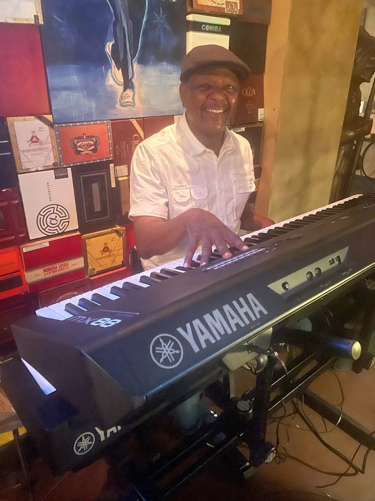Paul Bunn seated at Yamaha keyboard in music studio