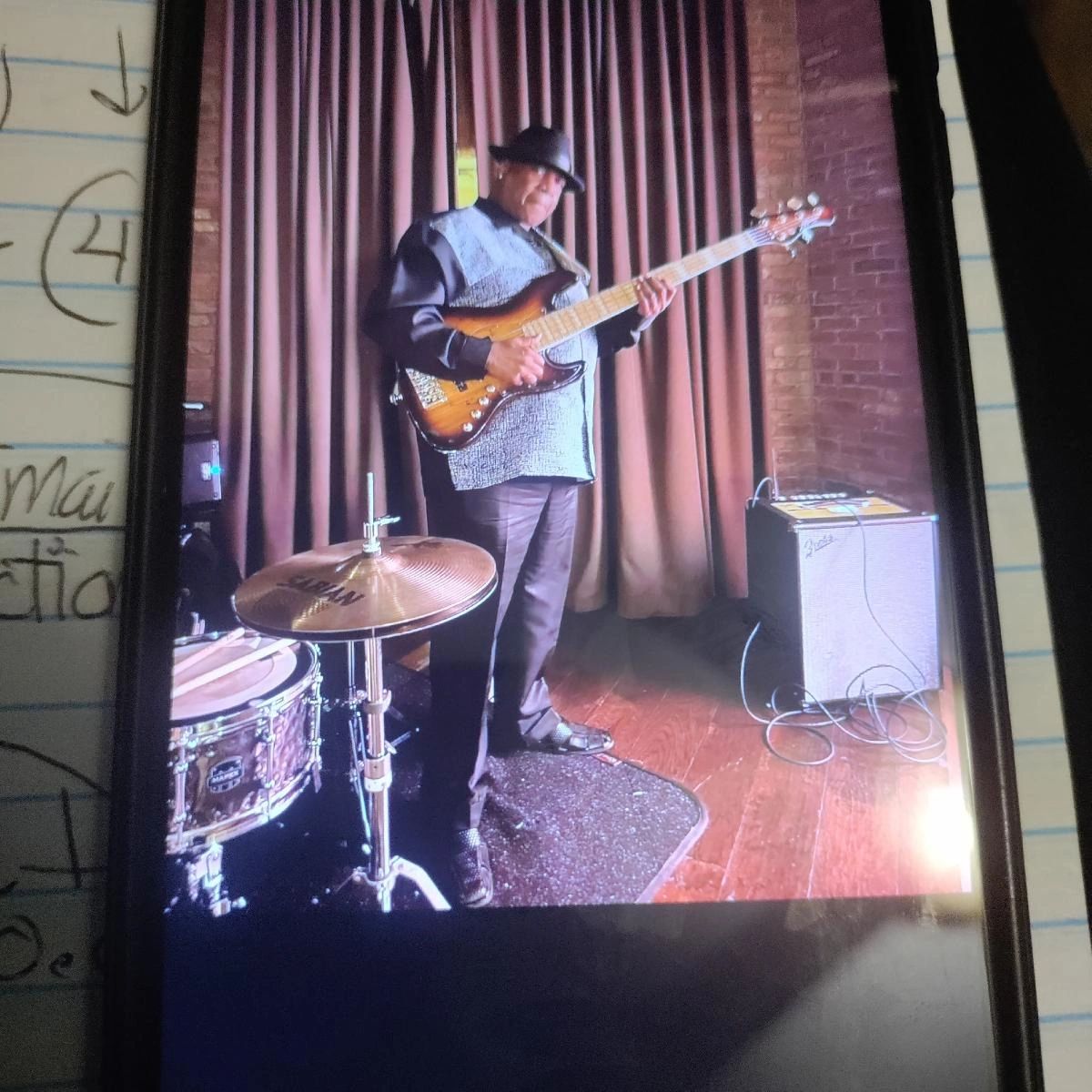 Ronnie Dorsey playing bass guitar on stage