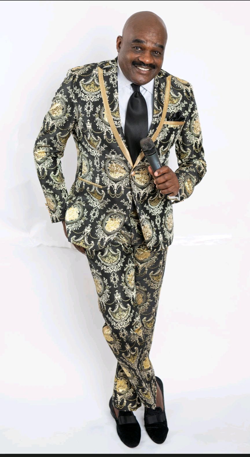 Julius Williams in black and gold patterned suit jacket portrait