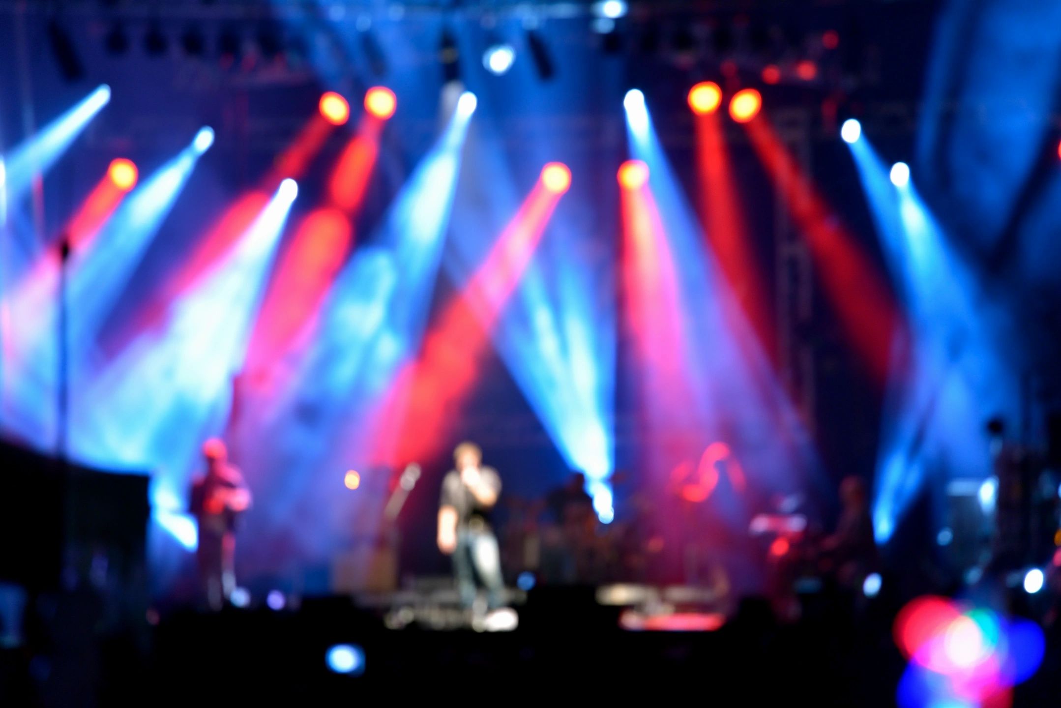 Vibrant concert stage with dramatic colored light beams